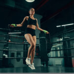Young,Athletic,Woman,Training,With,Jumping,Rope,On,Boxing,Ring